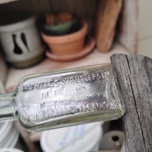 Vintage Glass Bottle with Embossed Text